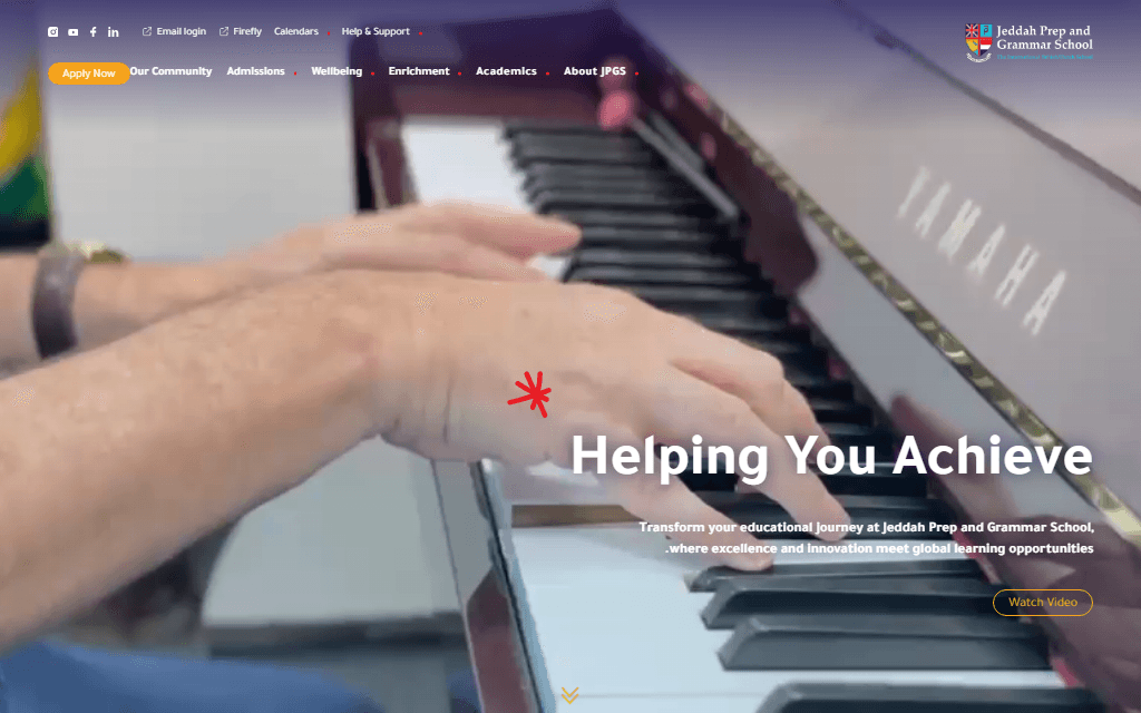 The /ar route's homepage header genuinely mirrored to RTL — the school logo moved to the top-right, nav and utility links reversed to read right-to-left — while the hero headline and body copy underneath are still rendered in English, including a visible bidi artifact where the intro paragraph's leading period wraps to the start of the line.