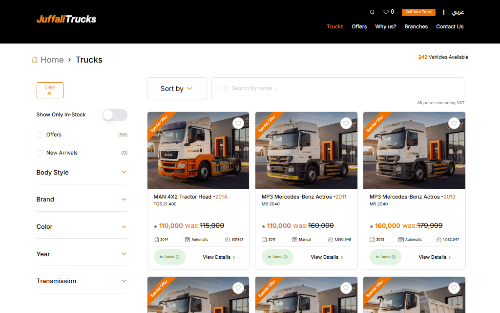 English /products truck listing page showing the filter sidebar (in-stock toggle, Offers, New Arrivals, Body Style/Brand/Color/Year/Transmission facets), sort/search bar, and a grid of truck cards with price, year, transmission, and mileage — a '242 Vehicles Available' counter